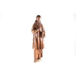 A large 18th-century Continental carved floor-standing hardwood figure of a cleric, dressed in