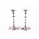 A matched pair of George II hollow cast silver candlesticks, London 1750 and 1751, one by William