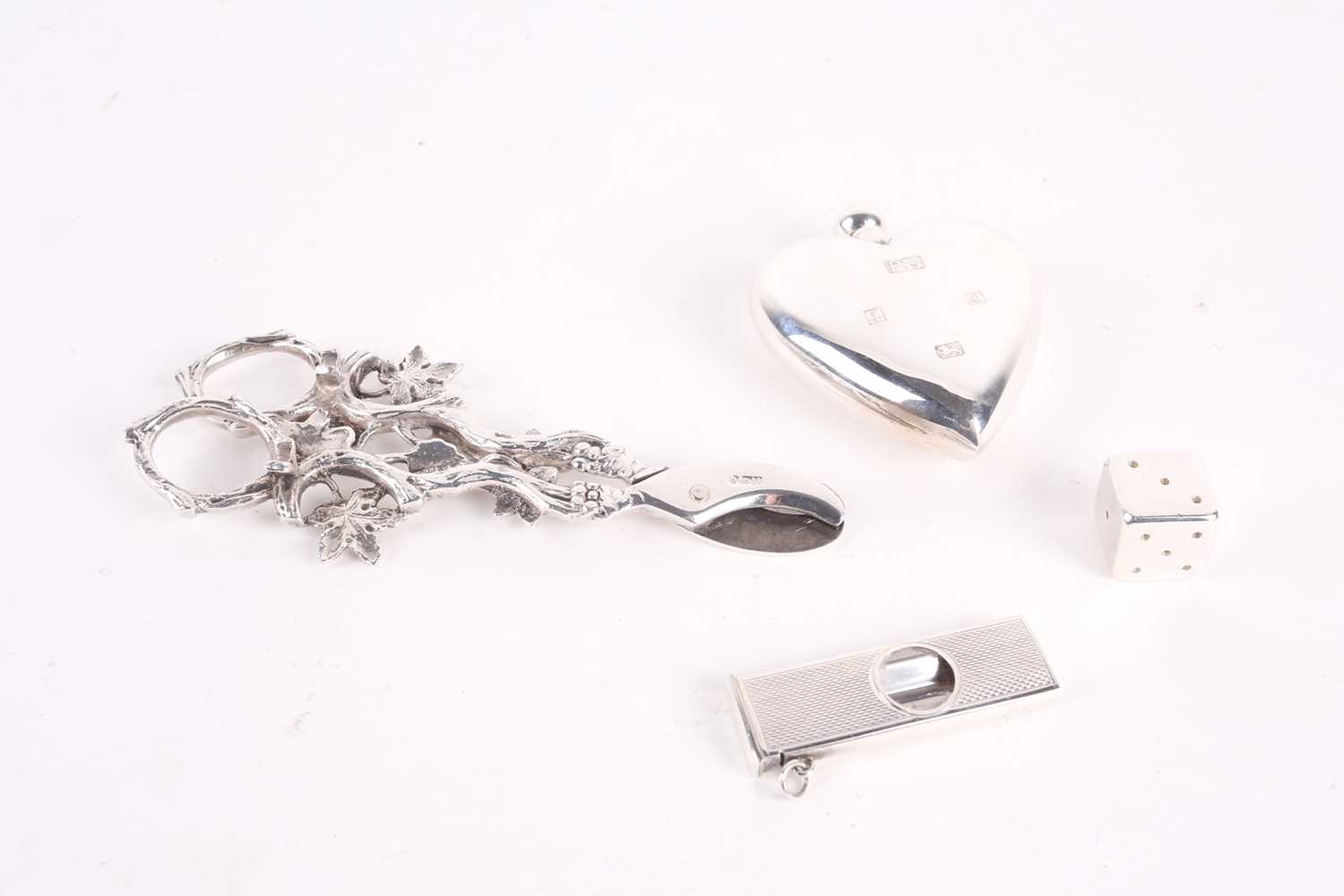 A group of small silver items, comprising a heart-shaped scent bottle, 7.2 cm high, a dice and a - Image 2 of 2