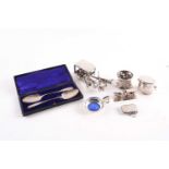 A mixed group of small silver items, to include a cased pair of spoons, an enamel-lined ashtray, a