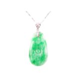 An 18ct white gold and jade pendant, of carved oval form, surmounted with a white gold and diamond