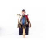 A 19th German musical marotte doll, with bisque head on a turned wooden handle, 34 cm high