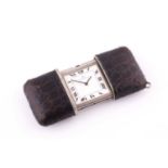 A purse watch by Movado The brown leather casing opening to reveal a square silver dial with Roman