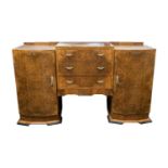 An Art Deco style figured walnut inverted breakfront sideboard, with a raised centre above a central