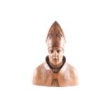 A Continental wood-carved head and shoulders bust of a Bishop, unpainted, circa 1700, 57 cm high x