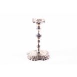 A George II period silver taperstick, London 1743 by John Cafe, with banded sconce, knopped stem and