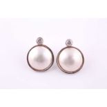 A pair of mabe pearl and diamond earrings Each collet-set brilliant-cut diamonds, approximately 0.