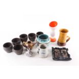 A collection of 20th-century studio pottery items to include a set of six Raku Chawan type cups, and