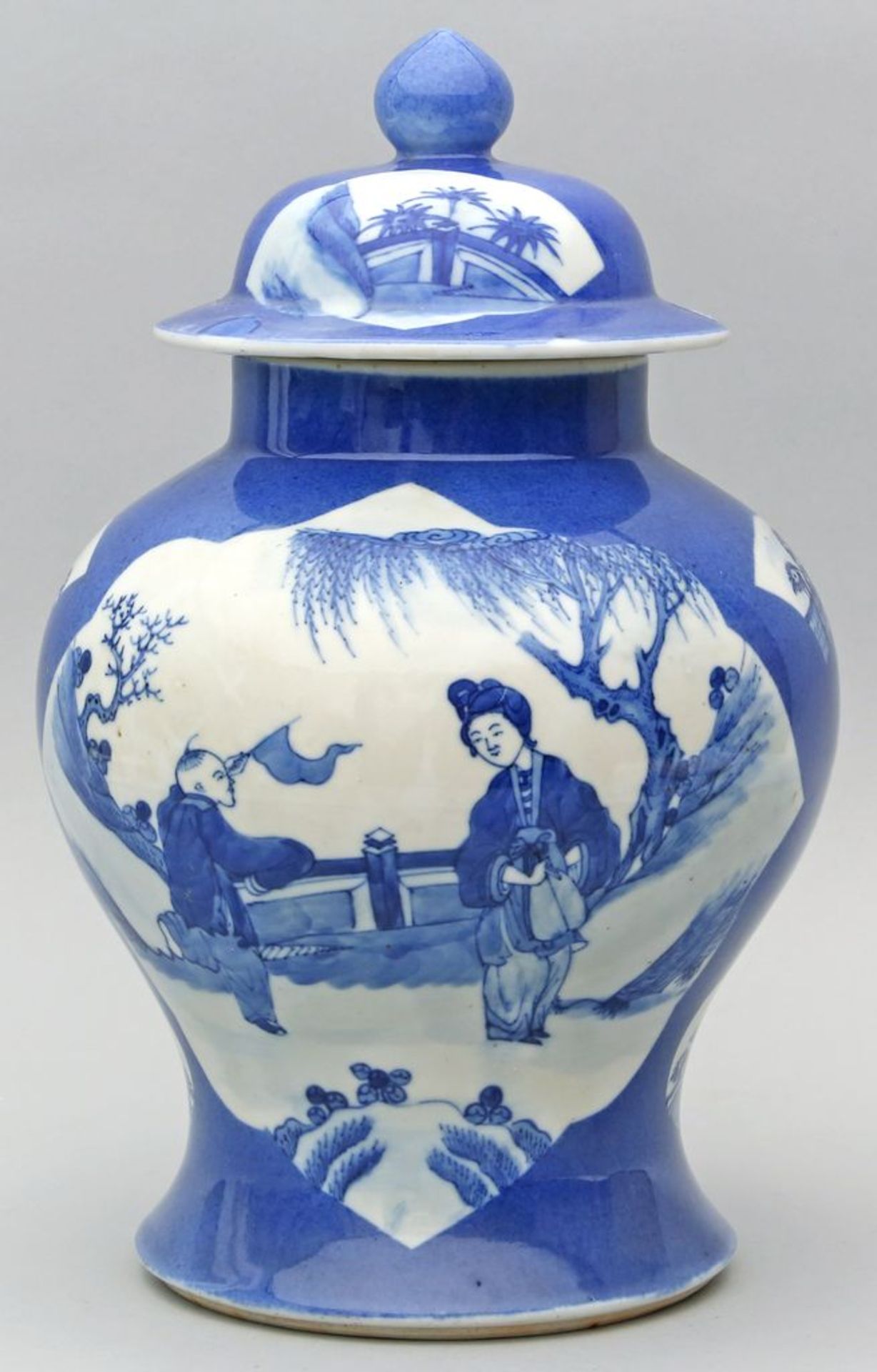 Deckelvase. Porzellan. In Reserven unterglasurblaue, figürliche Bemalung. China. H. 3