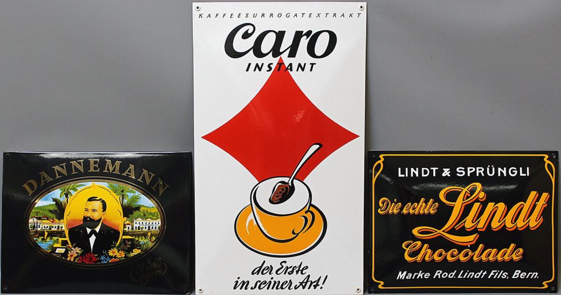 3 Emailschilder "Caro Kaffee", "DANNEMANN" und "Die echte Lindt".