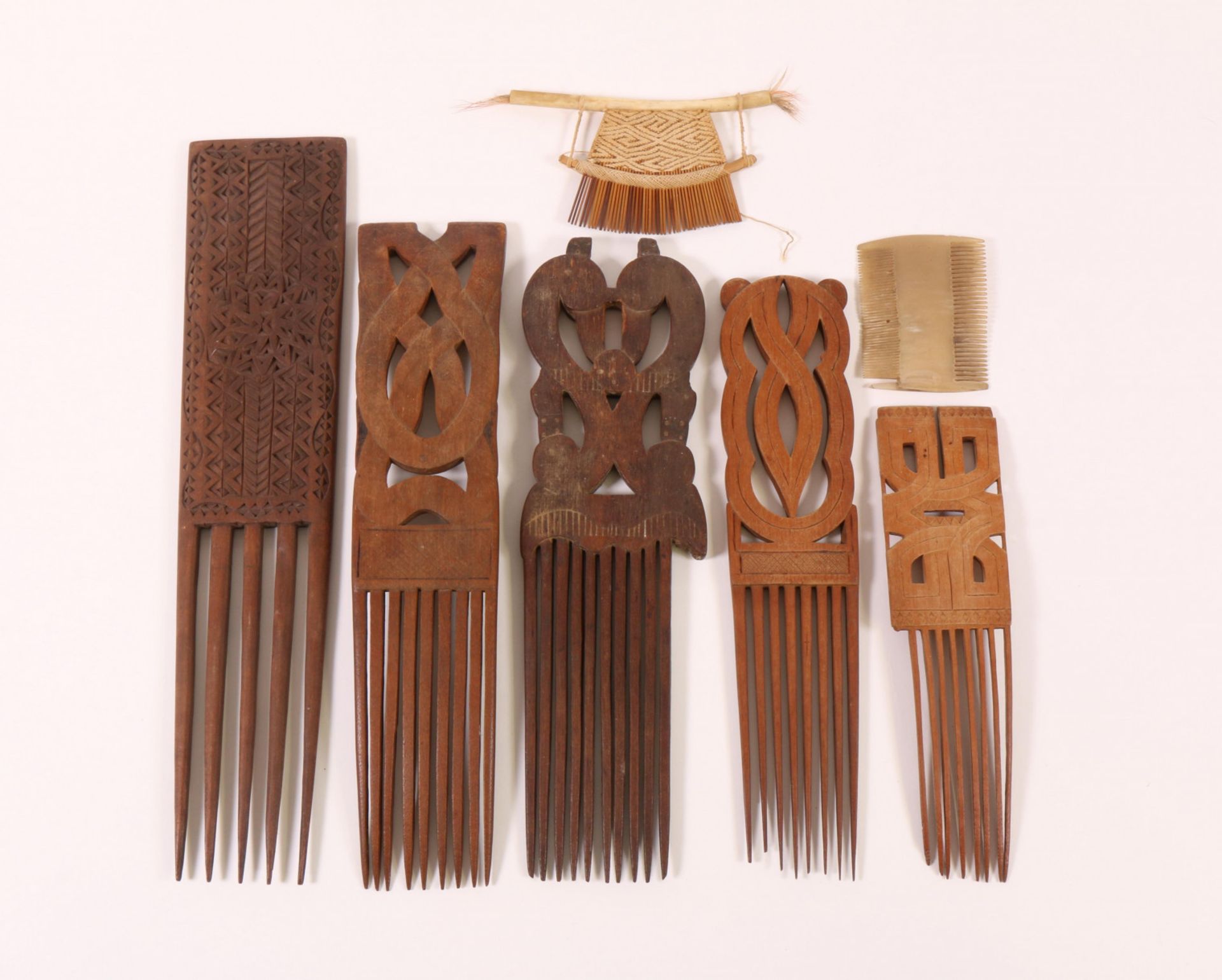 Surinam, collection of four wooden carved hair combs. Herewith two small hair combs.