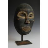 Borneo, Iban, carved wooden mask with painted accents in white.