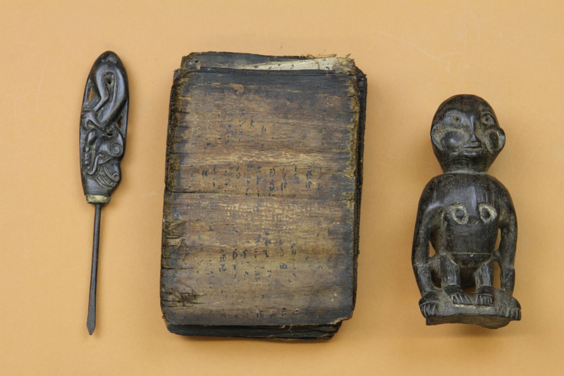 Dayak, braid prong and a carved wooden animal figure and Batak, a shaman book. - Image 2 of 5