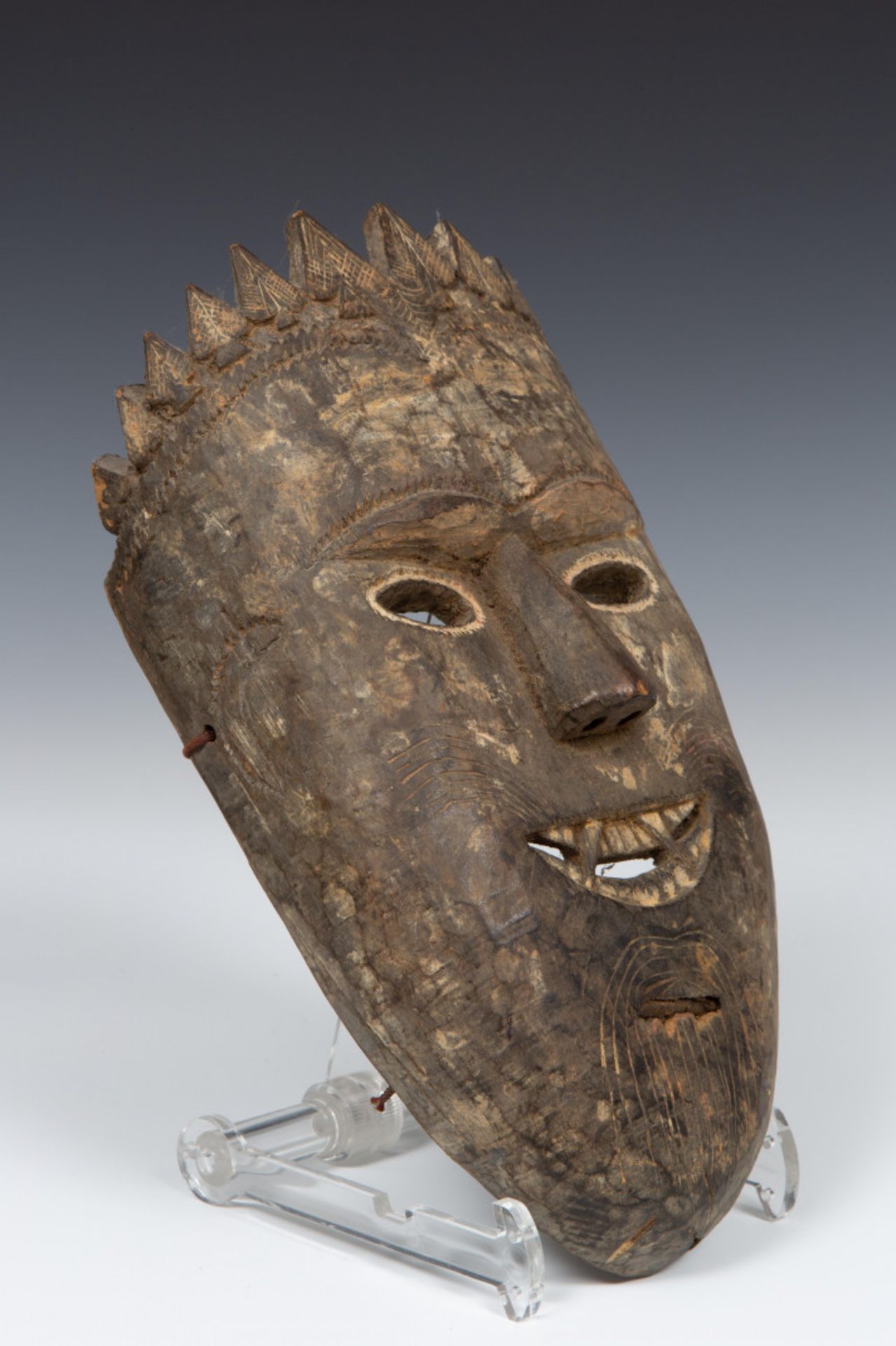 Nepal, carved wooden shaman mask with remains of lacquer seal, fangs, whiskers, goatee and crown,