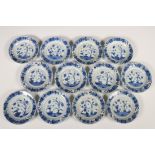 China, een set van twaalf blauw-wit porseleinen schoteltjes, Kangxi,