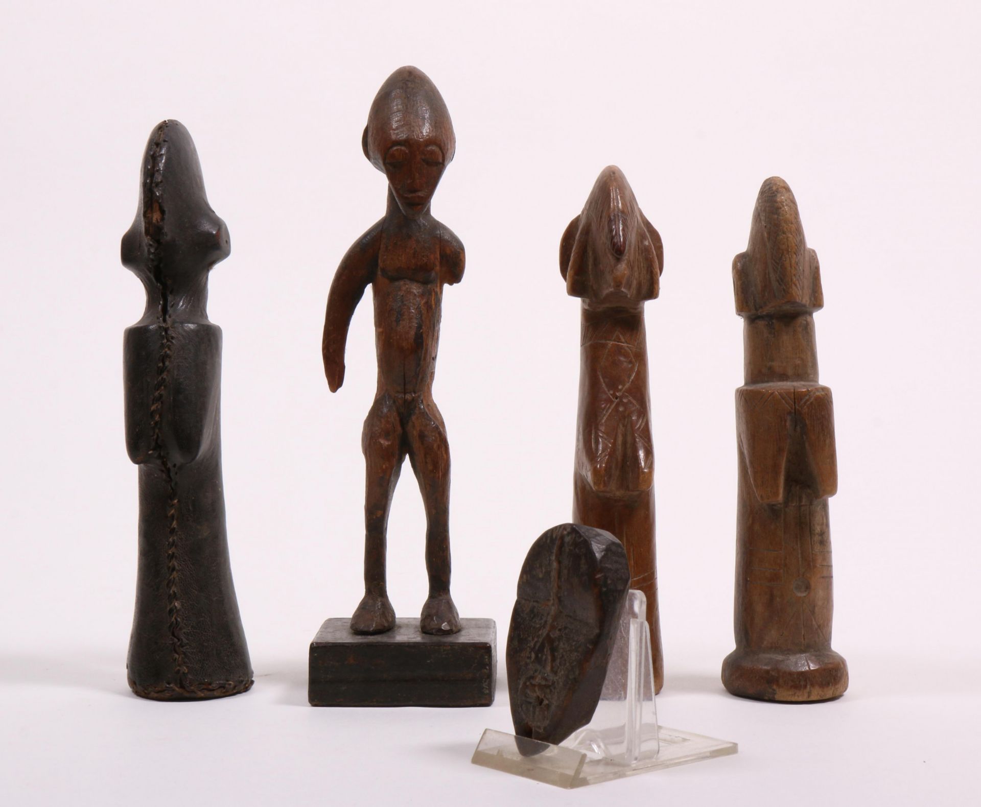 Three Mossi dolls, Bassa, miniature mask and a Mali figurine.