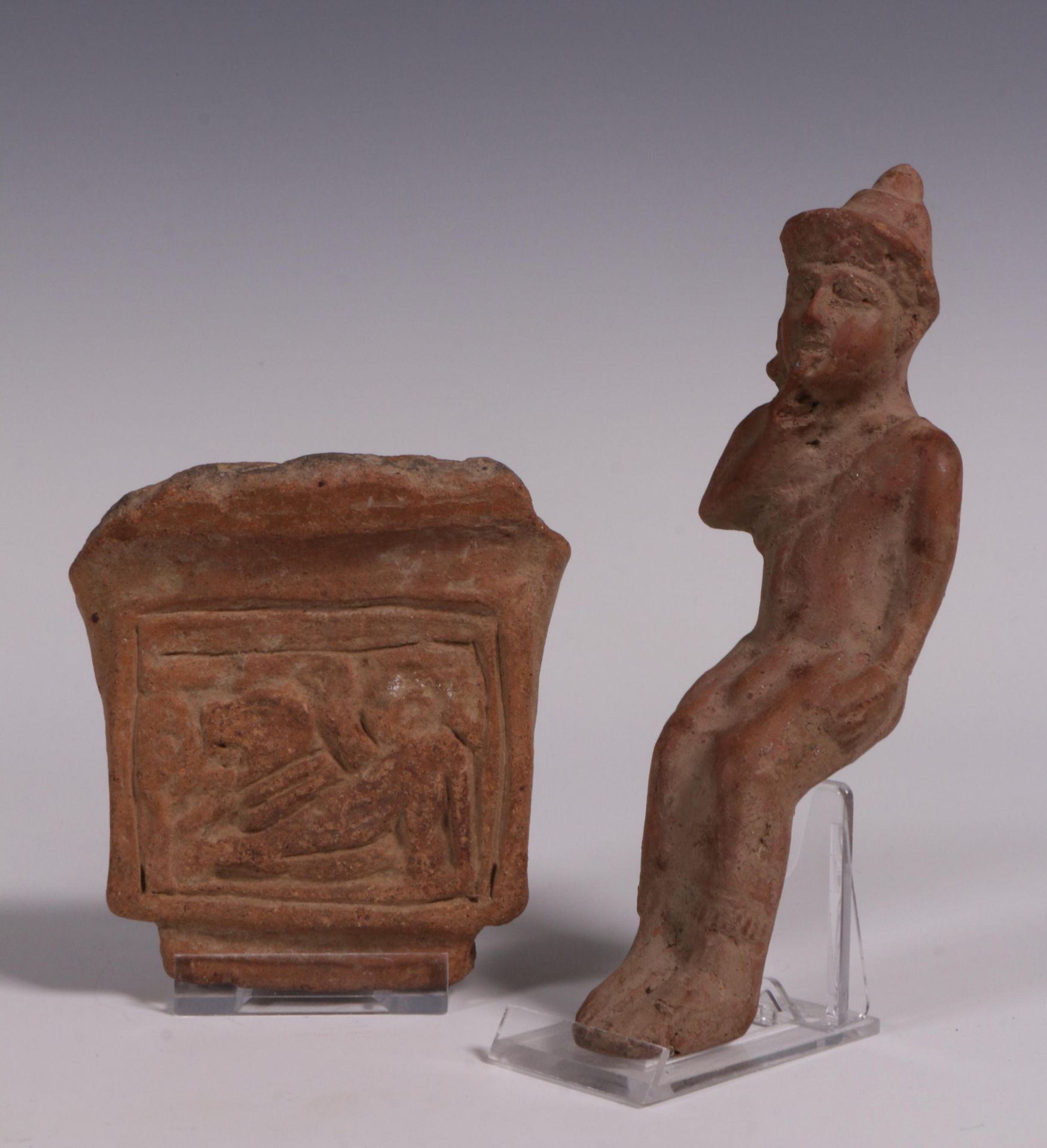 Antique terracotta fragment with relief decoration of a dog and an seated figure, possibly Greek.
