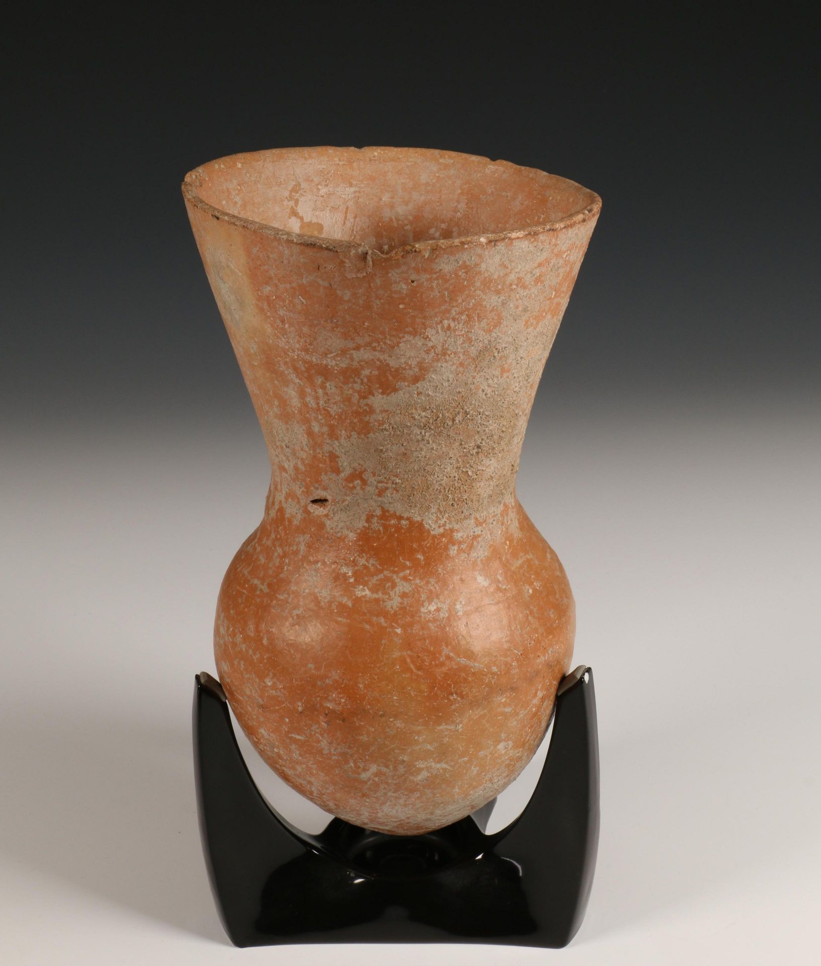 Hellenistic terracotta vase, 5th-4th century and a Roman fibula, 2nd century.