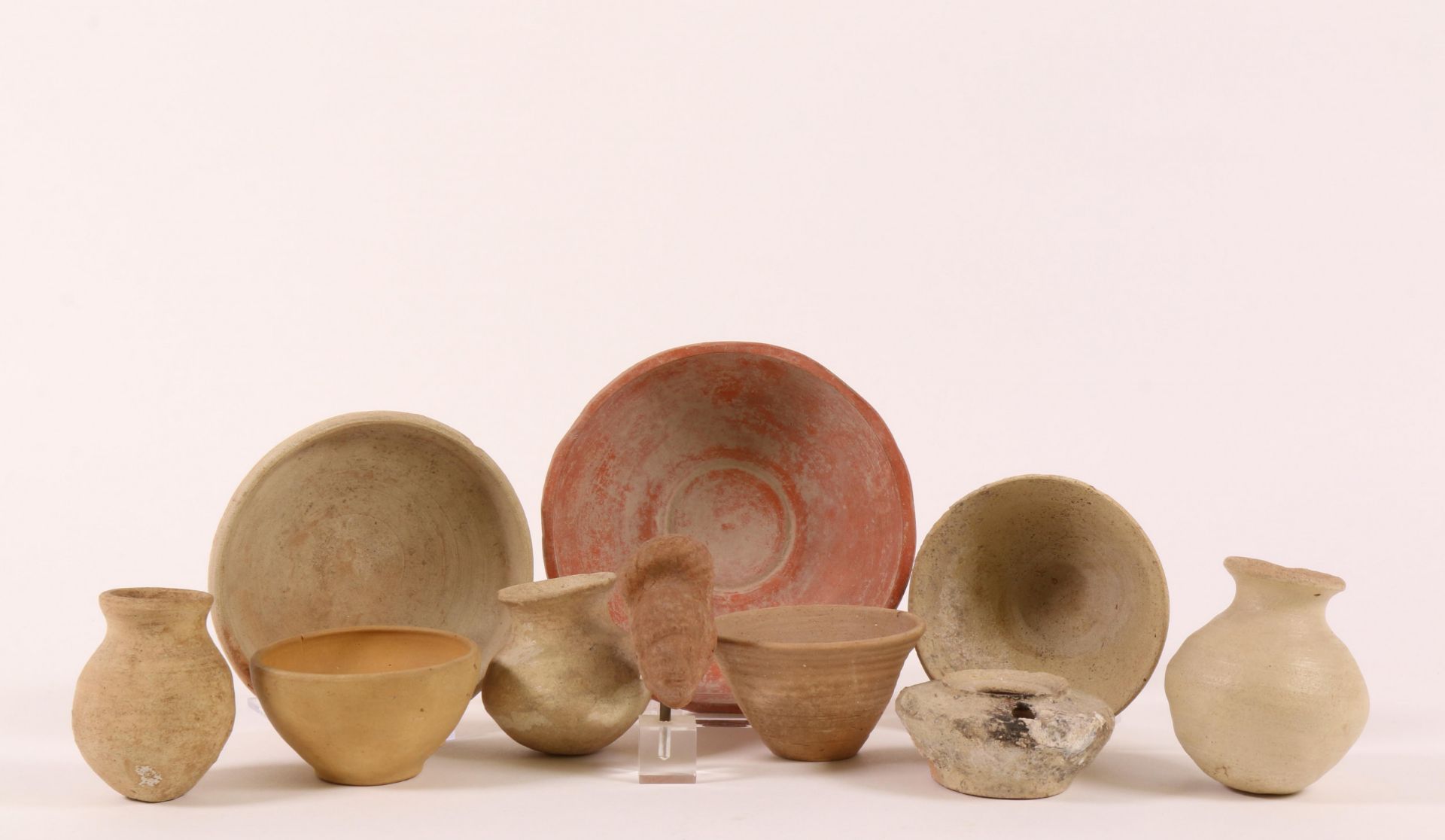 Collection of various archaeological objects; a terra sigillata dish, one jar and a small female hea