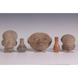 Collection of Precolumbian masks and two antique bottles