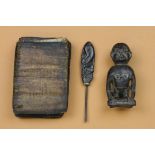 Dayak, braid prong and a carved wooden animal figure and Batak, a shaman book.