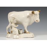 Delft, een witgeglazuurd aardewerken model van een melkmeid en koe, 18e eeuw,