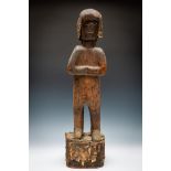 A standing wooden ritual figure, 19th century.