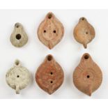 Collection of Roman oil lamps; four terracotta with decorations in