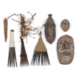 P.N.Guinea, Sepik, two earthenware heads, a wooden miniature mask; herewith three Melanesian combs a