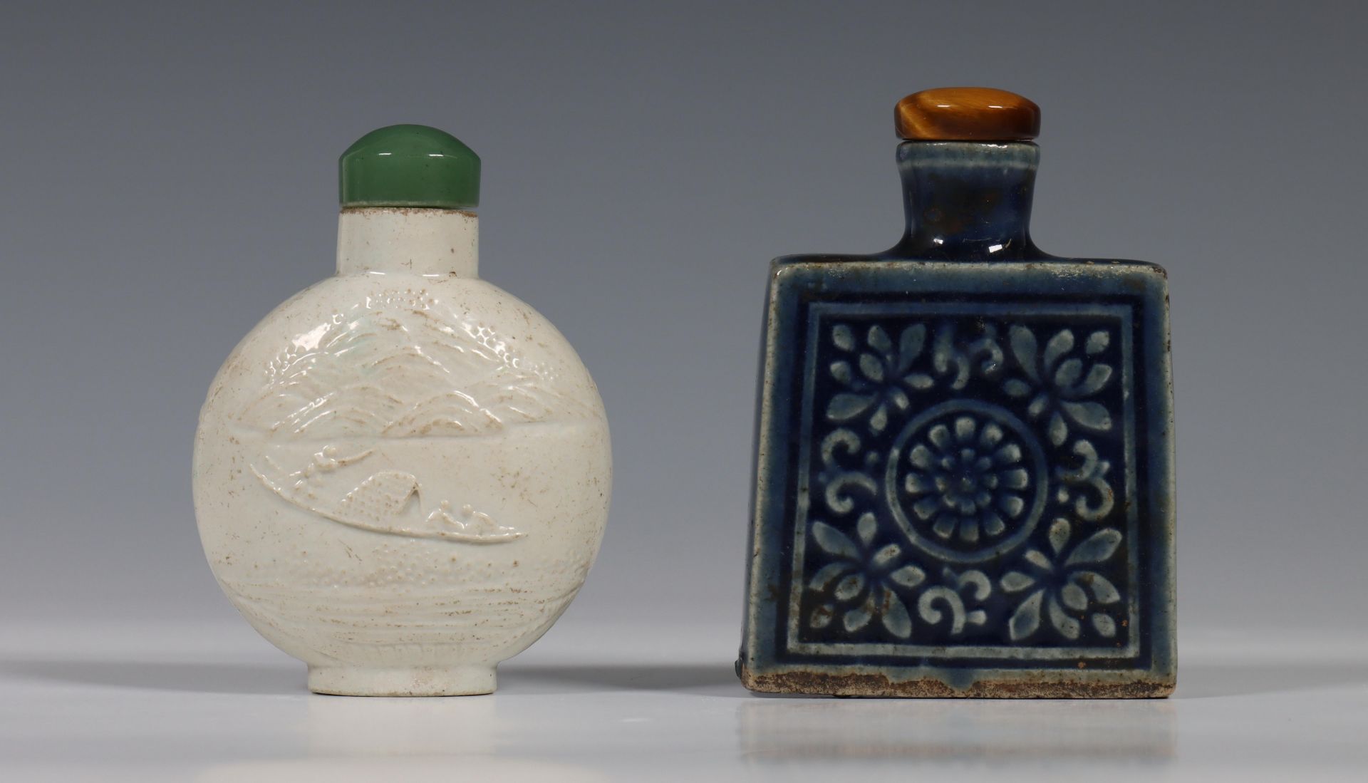 China, two porcelain snuff bottles, 20th century, one rounded bottle in biscuit and moulded with a - Image 2 of 2