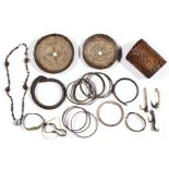 Melanesia, a collection of ornaments, two coconut shell discs, a braided rattan armlet, sixteen arm