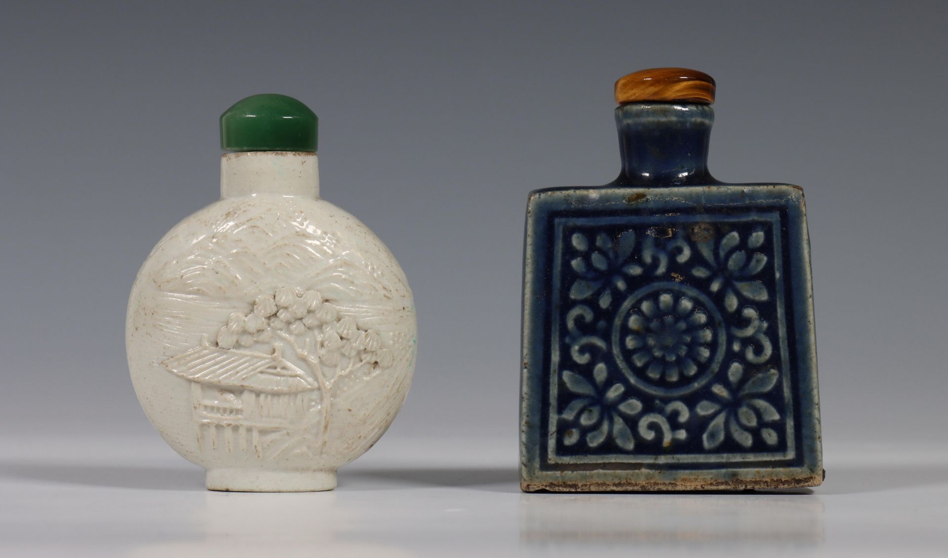 China, two porcelain snuff bottles, 20th century, one rounded bottle in biscuit and moulded with a