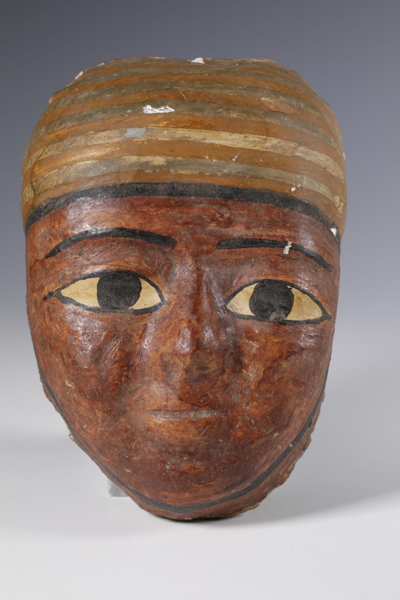 Egypt, a stucco canvas mummy mask, Ptolomeic Period.