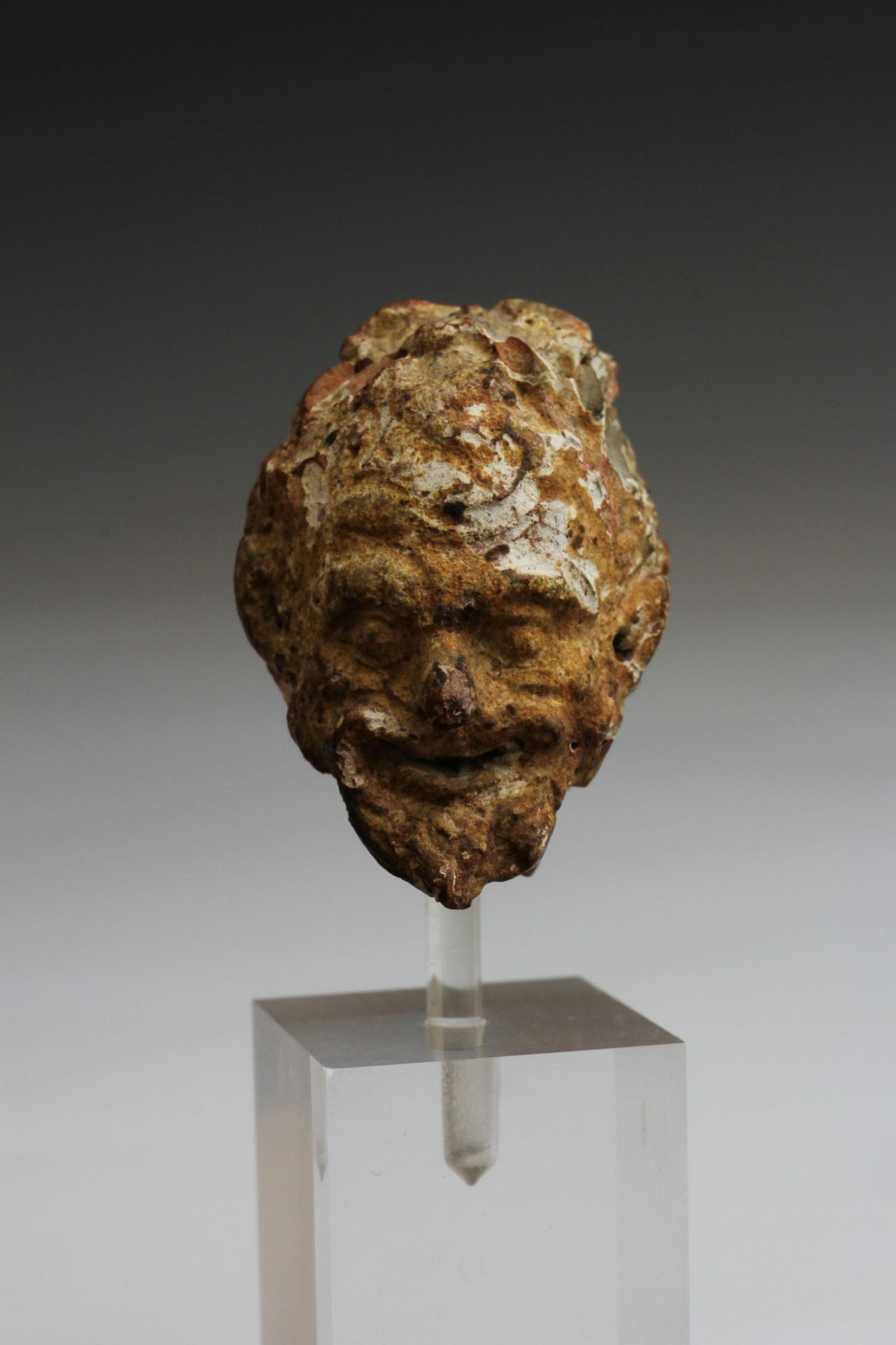 A Greek terracotta fine head of a Satyr, ca. 4th century BC.