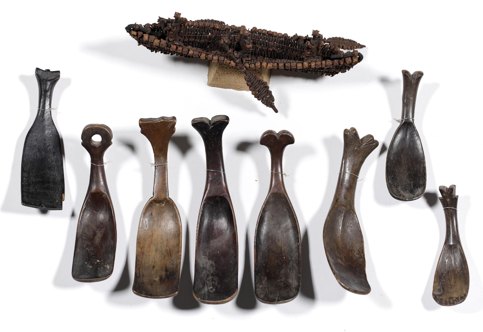 Sulawesi, Toraja, eight various wooden spoons; herewith an Ambon clove boat with three rowers
