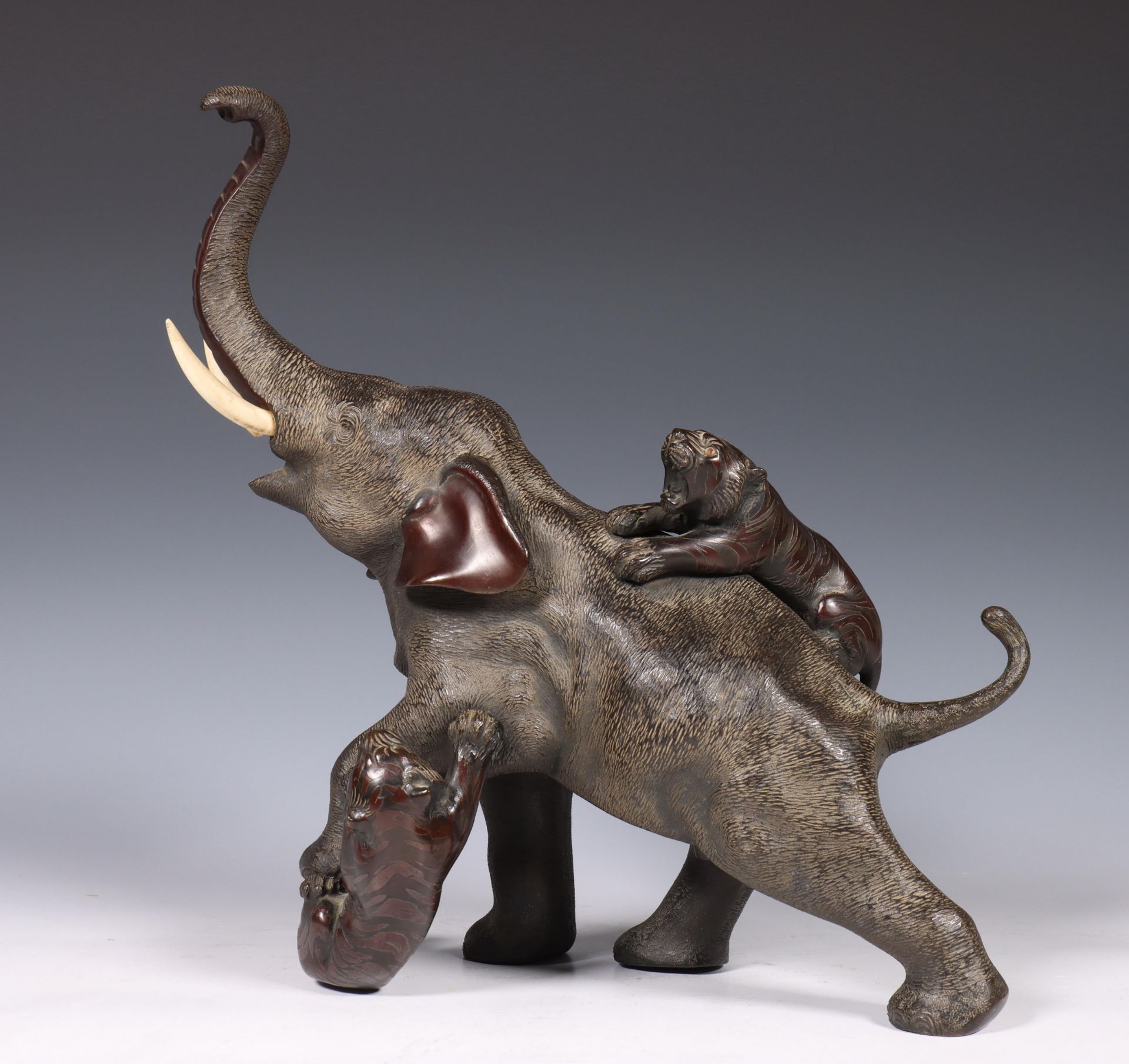 Japan, bronze sculpture of an elephant, 19th/early 20th century, the animal being attacked by two