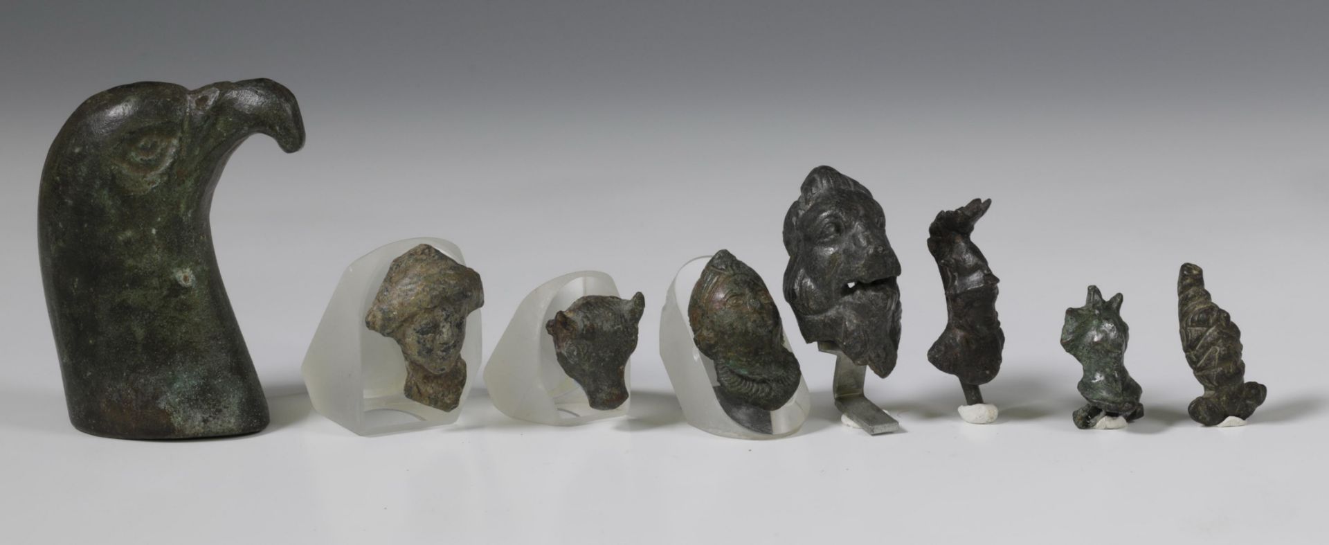 Roman bronze head of a falcon, and a collection of nine Roman bronze human- and animal heads, ca. 1s - Image 3 of 4