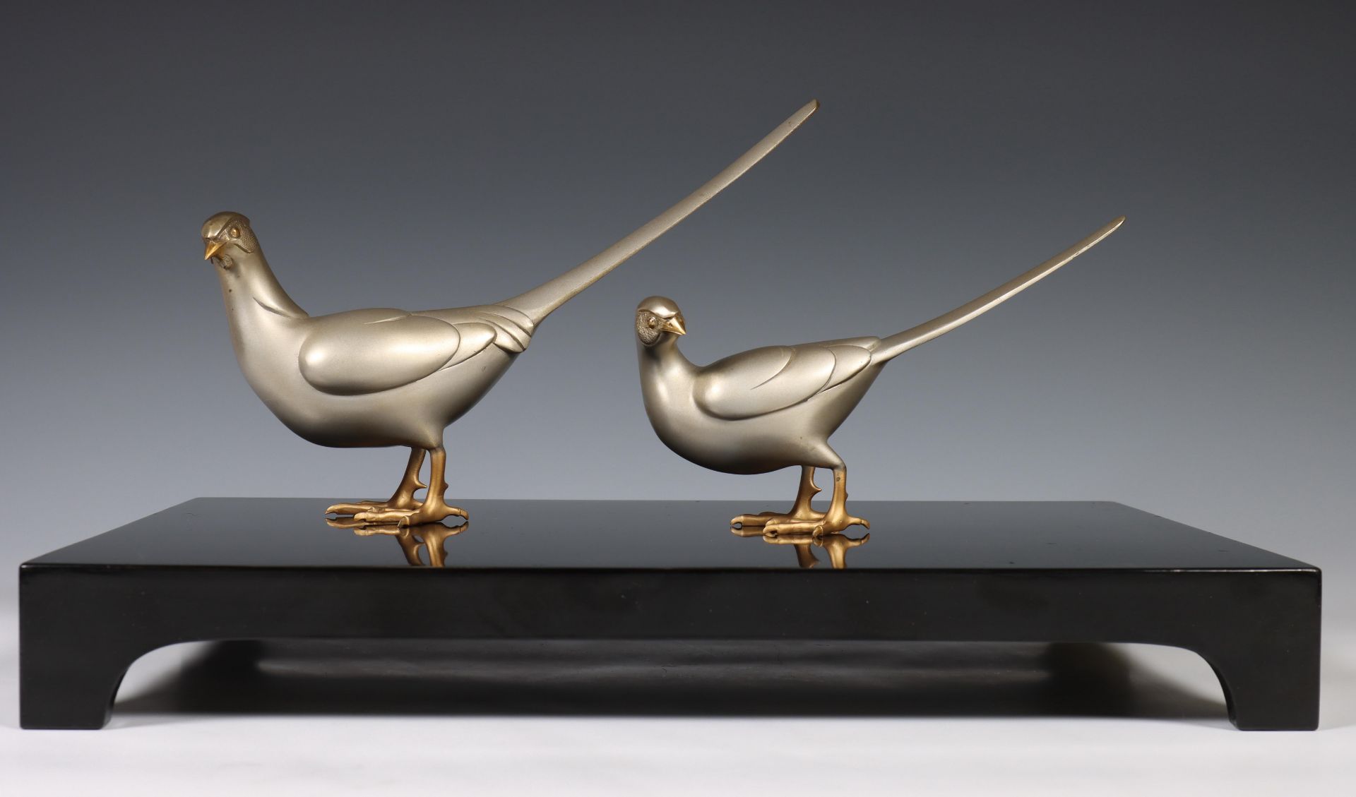 Japan, white bronze okimono of two pheasants, Showa period, signed, the two loose animals on a stand