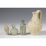 Two Roman glass bottles and a terracotta flask, 2nd-3rd century.