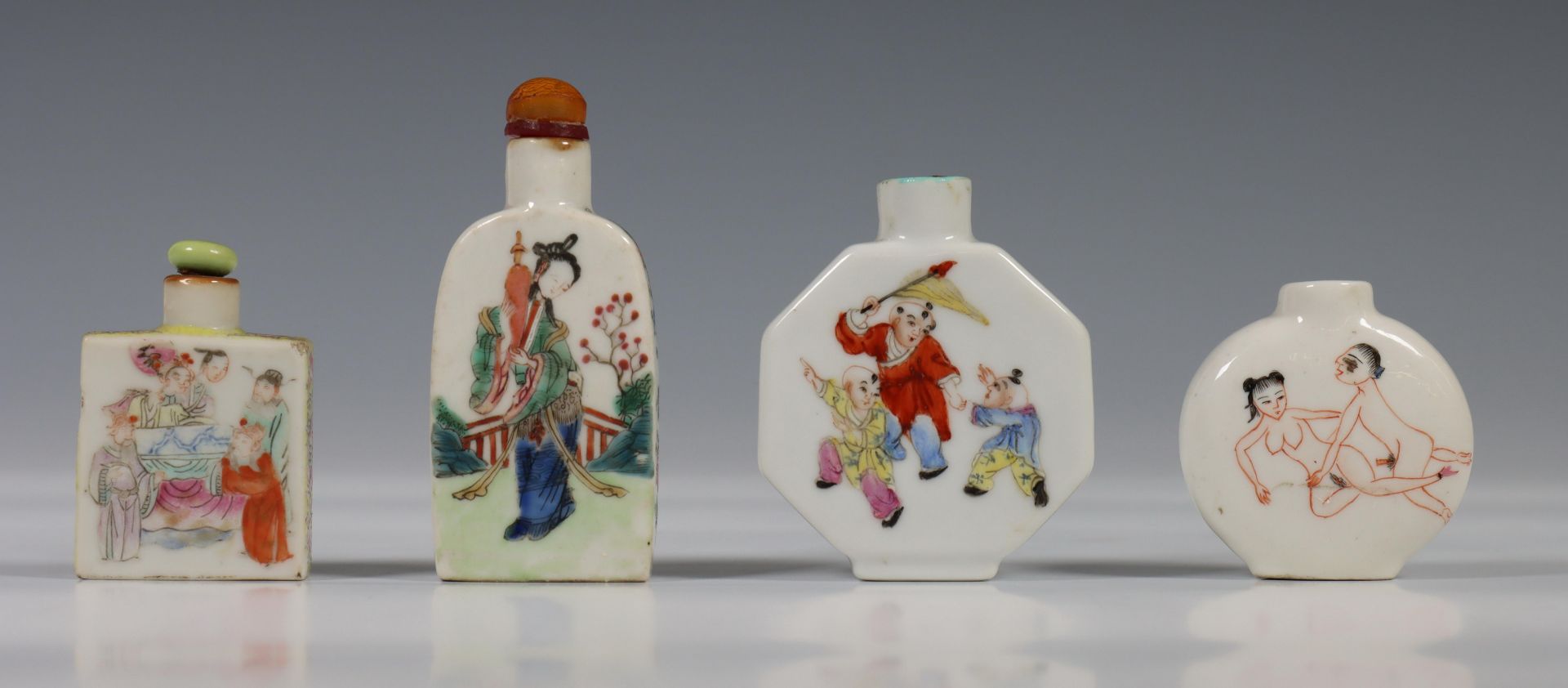 China, four figural porcelain snuff bottles, one decorated with figures in a garden, one with erotic