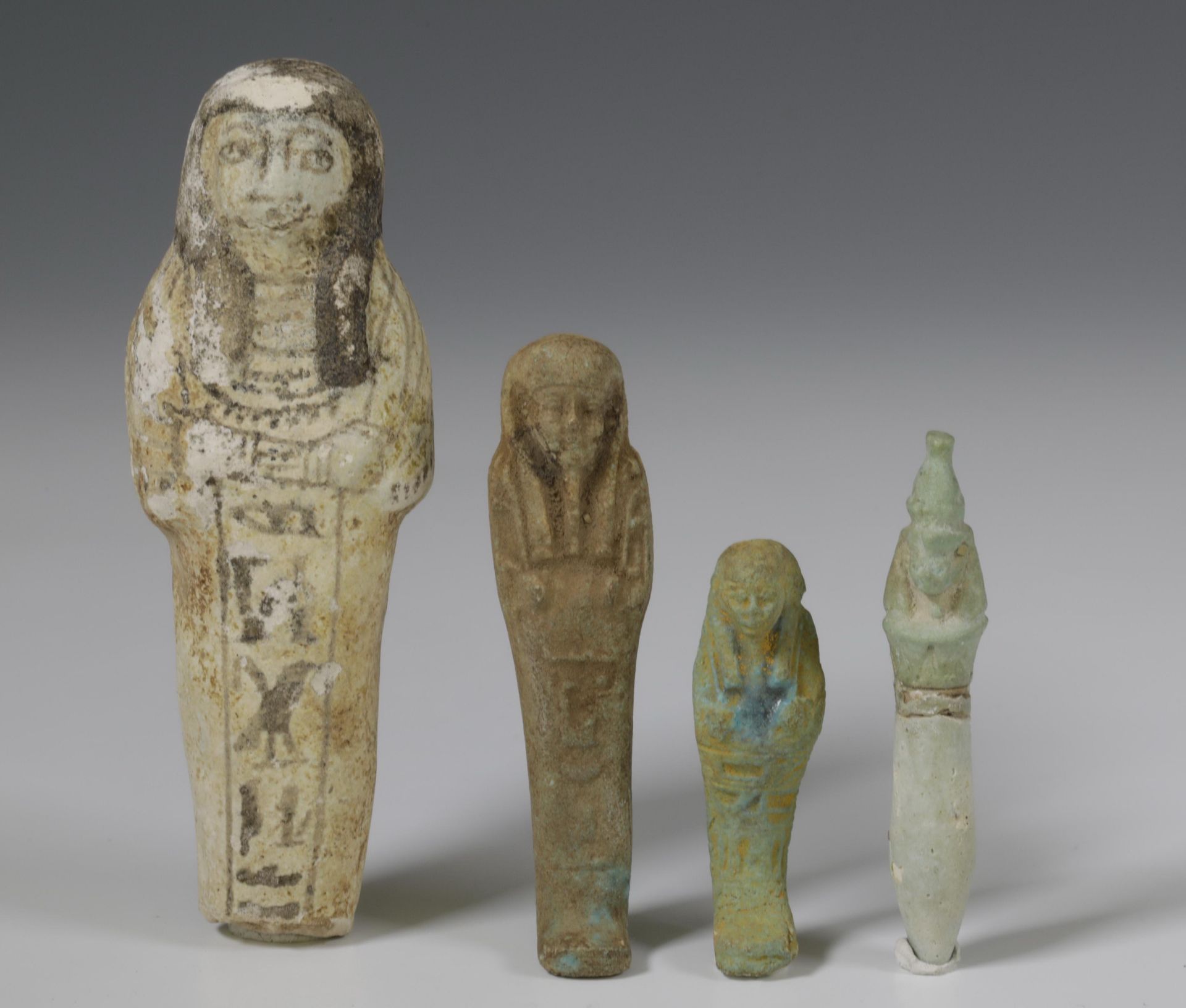 Egypt, three terracotta Ushabti's and an amulet, Late Period;