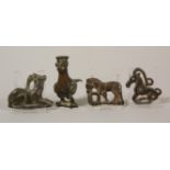 Four Ordos style applieques and a possible Persian bronze figure of a standing bird.