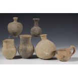 A collection of six antique terracotta pots and a jug of Roman period and later.