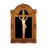 Richly carved ivory Corpus on a wooden cross