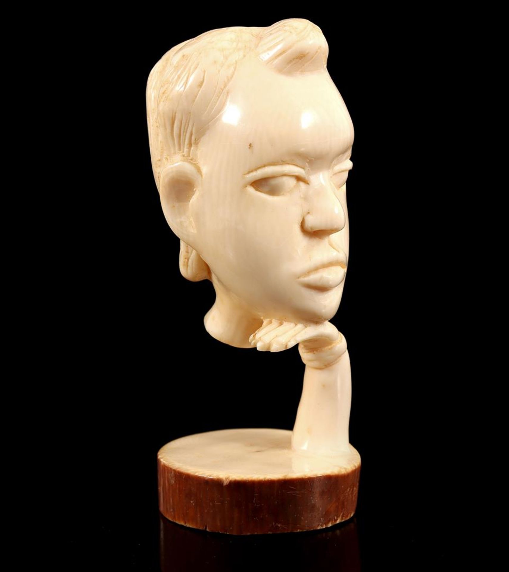 Carved ivory bust of a woman's face