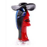 Colored glass statue of figure with hat