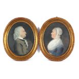 2 oval portraits of man and woman