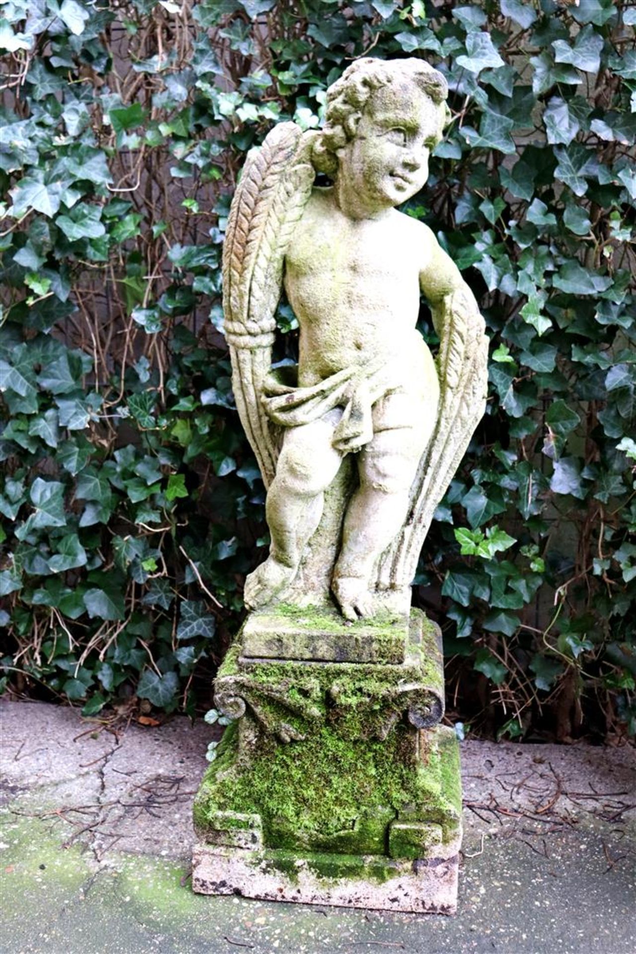 Sandstone garden statue on pedestal