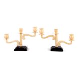 2 Art Deco ivory 3-light table candlesticks on a wooden base