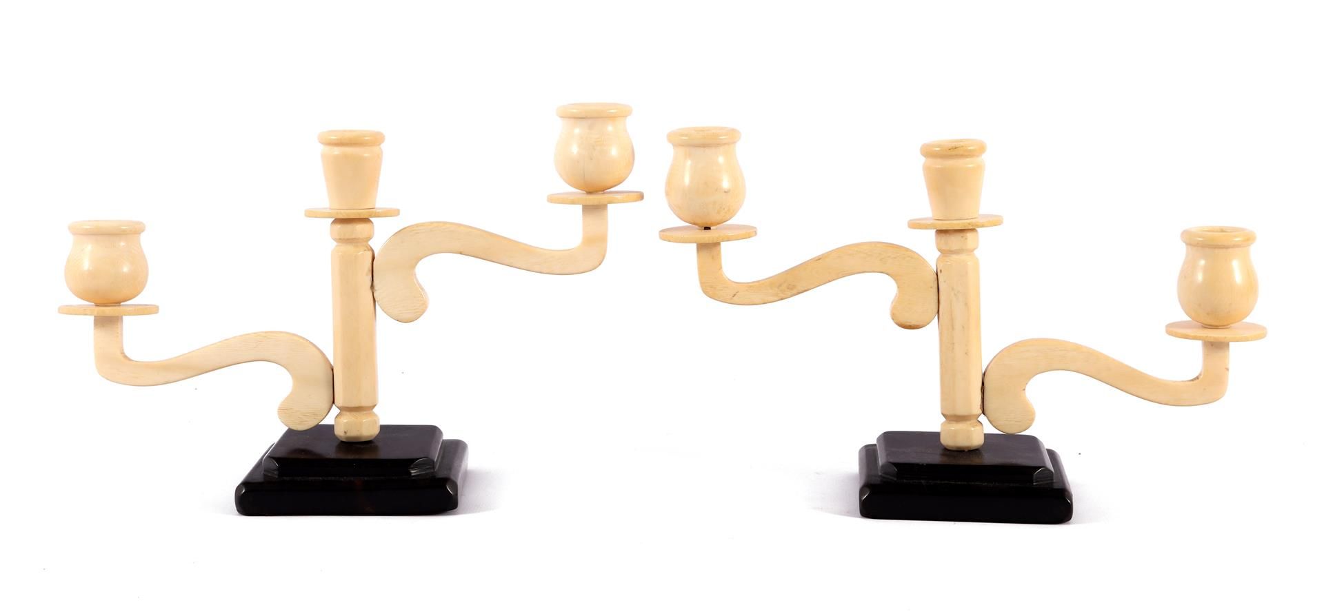 2 Art Deco ivory 3-light table candlesticks on a wooden base